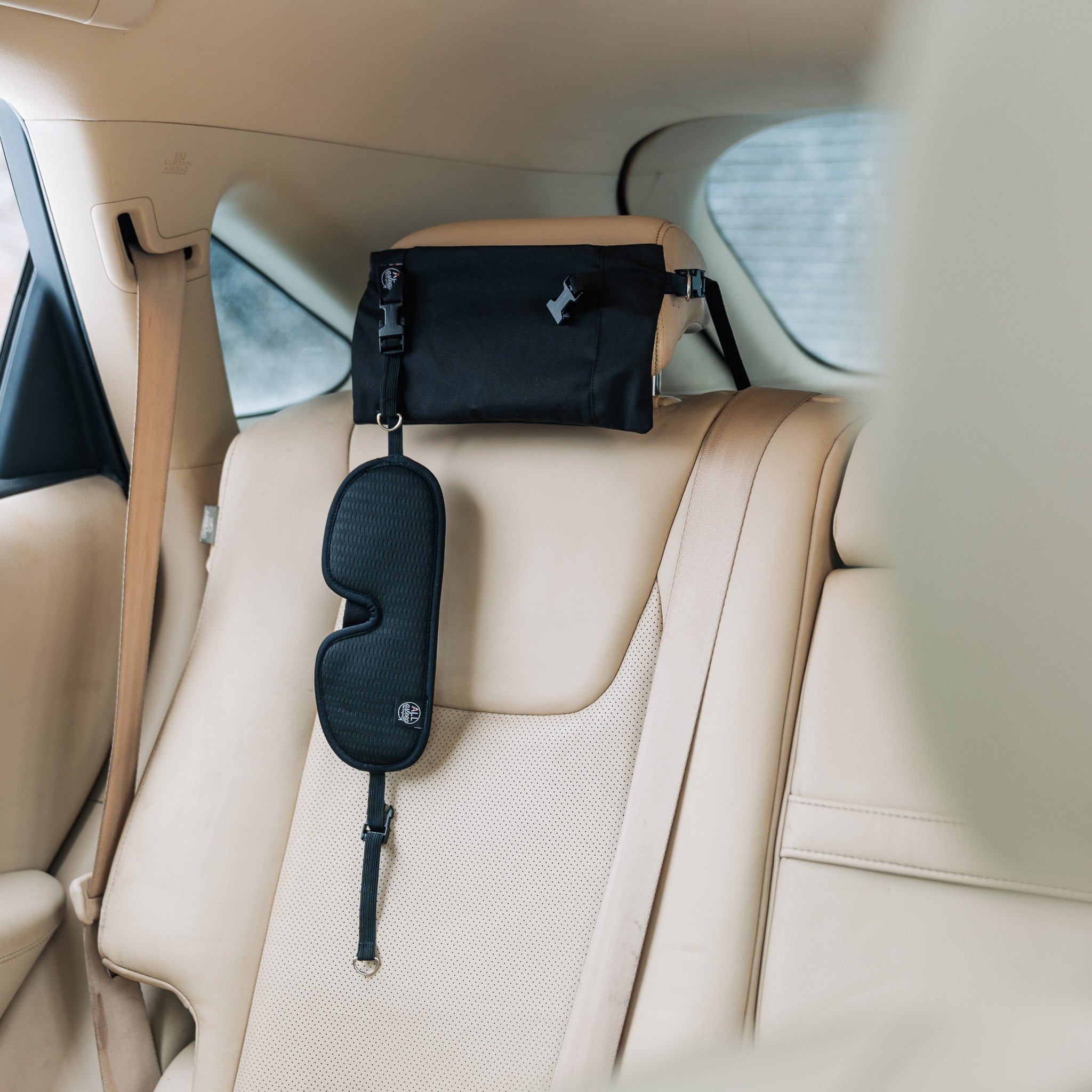 product view of the ALLasleep travel accessory installed on the back seat of a car