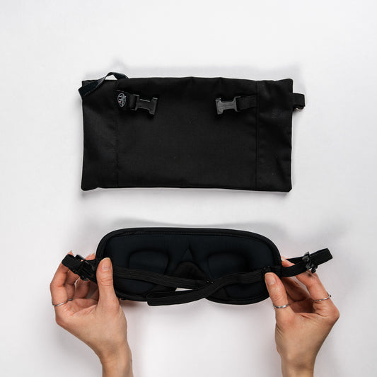 Top view of the headrest pouch and a pair of hands showing the backside of the eye mask.