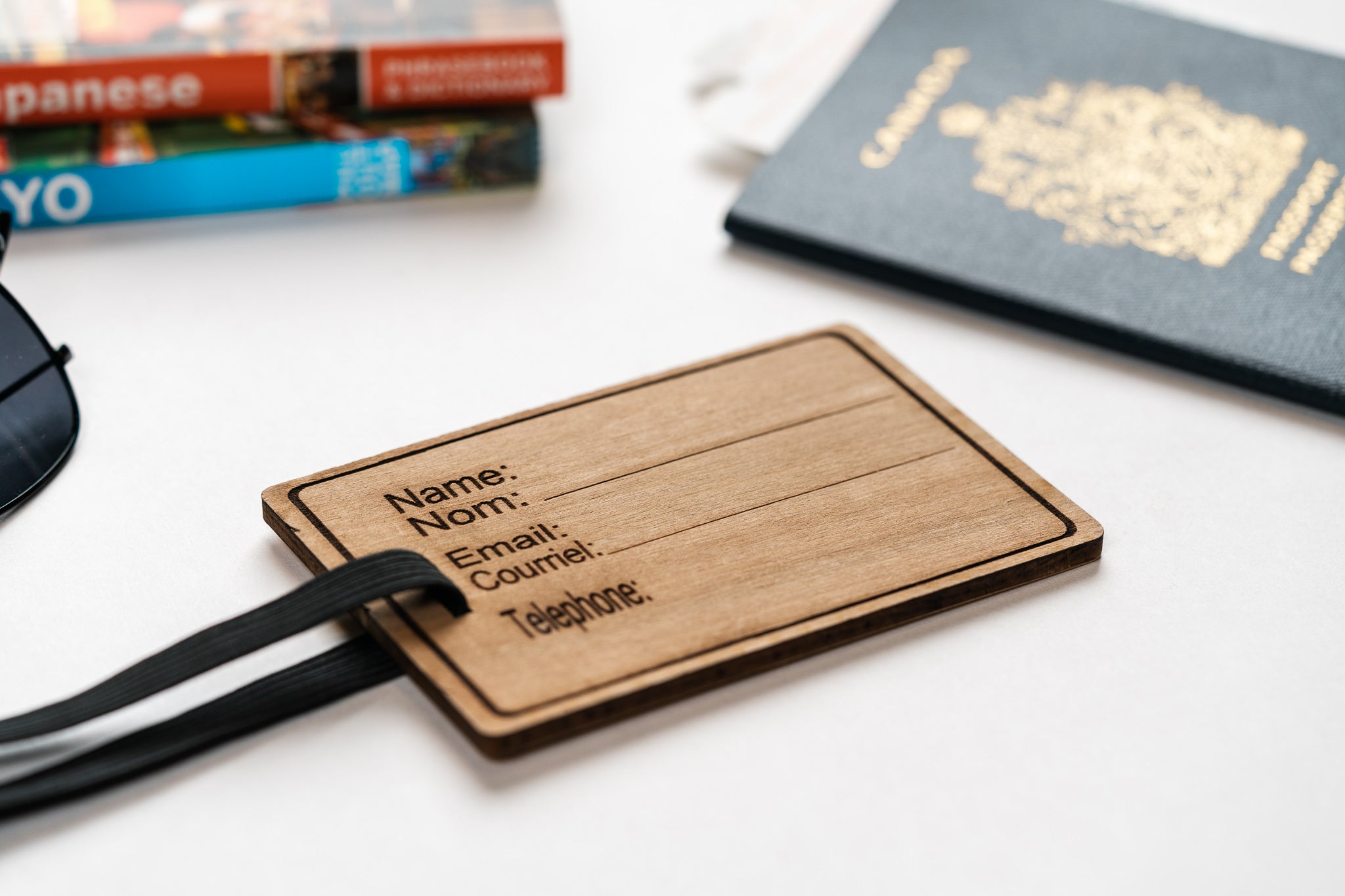 Close up view of wooden luggage tag included with the ALL inclusive travel kit